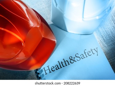 Health And Safety With Red And White Helmets