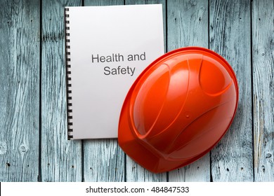 Health And Safety Register With Helmet In Closeup
