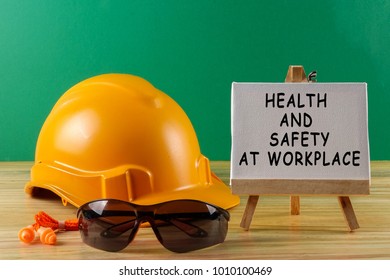 HEALTH AND SAFETY AT WORKPLACE CONCEPT. Yellow Hardhat Safety Helmet,safety Glass And Ear Plug. 