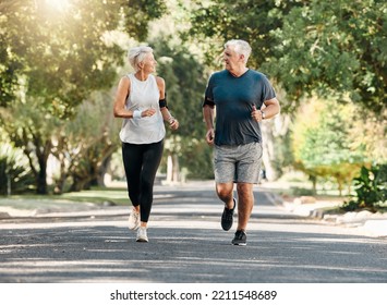 Health, senior couple and running while talk and exercise for fitness, wellness and healthy together in nature. Retirement, man and woman enjoy workout, chatting and jog outside in park on sunny day - Shutterstock ID 2211548689