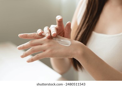 Health skin care, beauty smile asian young woman, girl  hand applying, putting moisturizer on her arm, shoulder after shower bath at home. Skin body cream moisturizing lotion, routine in the morning. - Powered by Shutterstock