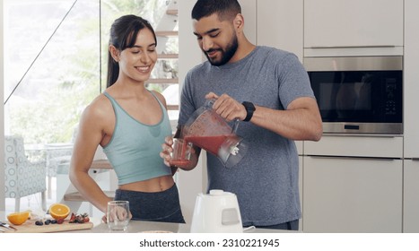 Health smoothie, couple and fitness nutritionist with fruit, healthy food and smile at home. Nutrition, breakfast and diet of a woman and man together with juice blender and happiness from cooking - Powered by Shutterstock