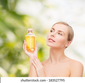 Health, Spa And Beauty Concept - Lovely Woman With Oil Bottle