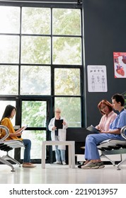 Health Specialist Discussing With Senior Woman In Hospital Waiting Room, Filling Report Papers Explaining Healthcare Treatment. Nurse Doing Checkup Examination With Asian Patient In Lobby.