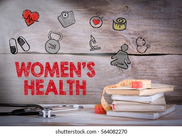 WomensÃ¢??s Health. Stack Of Books And A Stethoscope On A Wooden Background