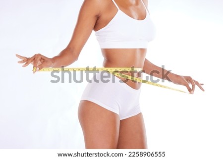 Health, stomach and diet, woman with measuring tape on waist, exercise and weightloss isolated on white background. Fitness, healthcare and tummy tuck motivation or liposuction progress in studio.