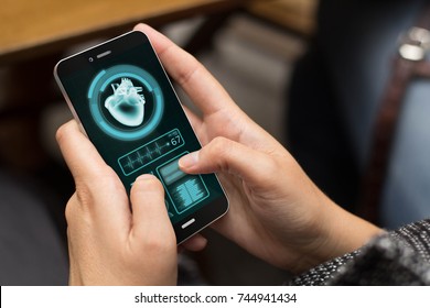 Health And Technology Concept: Girl Using A Digital Generated Phone With Medical App On The Screen. All Screen Graphics Are Made Up.