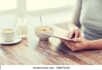 Health, Technology, Internet, Food And Home Concept - Close Up Of Woman Reading Morning News From Tablet Pc Computer