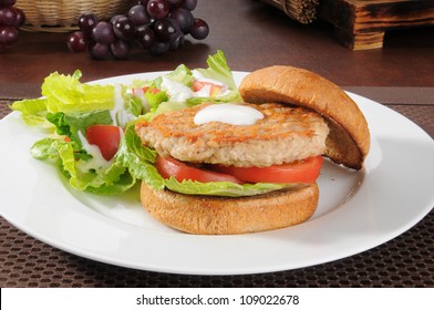 A Health Turkey Or Chicken Burger With A Salad