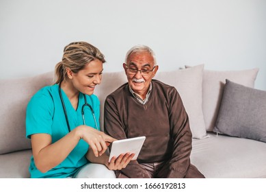 Health Visitor And A Senior Man During Home Visit. A Female Nurse Or A Doctor Showing Test Results On A Tablet. Senior Patient And Caregiver Using Tablet. I Found Some Entertainment For You