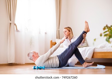 Health Visitor And Senior Man During Home Visit.