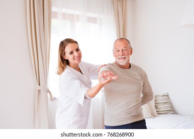 Health Visitor And Senior Man During Home Visit.