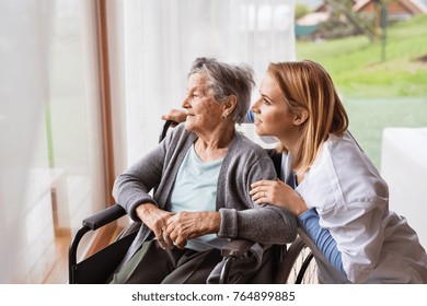 Health Visitor And A Senior Woman During Home Visit.