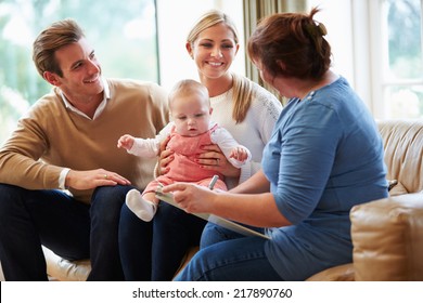 Health Visitor Talking To Family With Young Baby