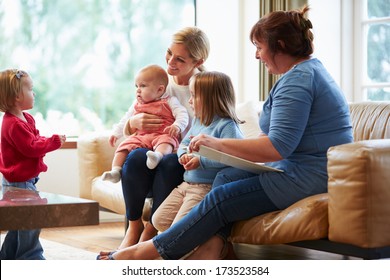 Health Visitor Talking To Mother With Young Children