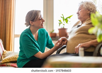 Health Visitor Talking To A Senior Woman During Home Visit
