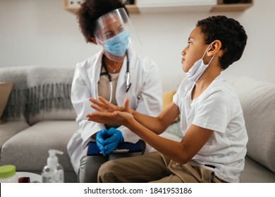 Health Visitor And A Young Boy During Home Visit