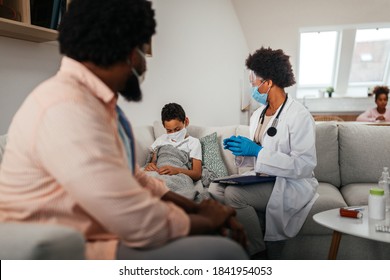 Health Visitor And A Young Boy During Home Visit