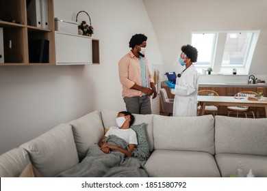 Health Visitor And A Young Boy During Home Visit