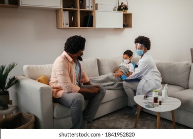 Health Visitor, Young Boy And His Father During Home Visit