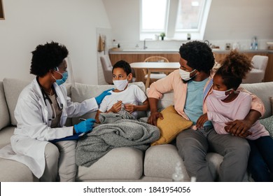 Health Visitor, Young Boy And His Family During Home Visit