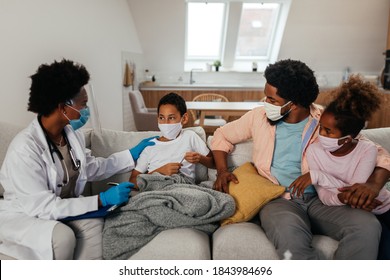 Health Visitor, Young Boy And His Family During Home Visit