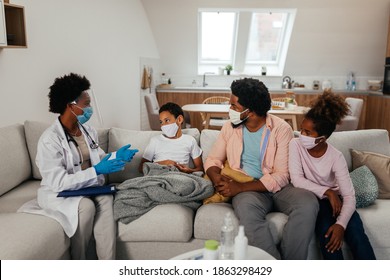 Health Visitor, Young Boy And His Family During Home Visit