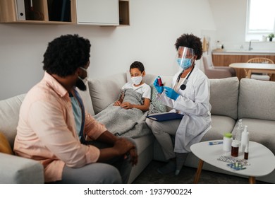 Health Visitor, Young Boy And His Father During Home Visit