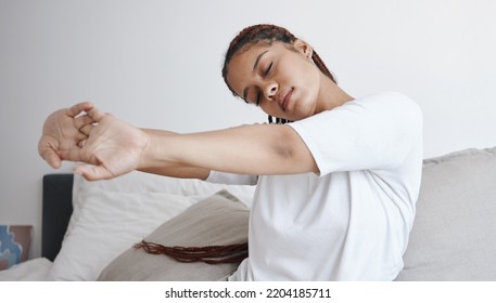 Health, wellness and zen, woman stretching on bed in the morning to start new day. Motivation to get up, young student stretching before going to school. Mental preparation in the bedroom to wake up. - Shutterstock ID 2204185711