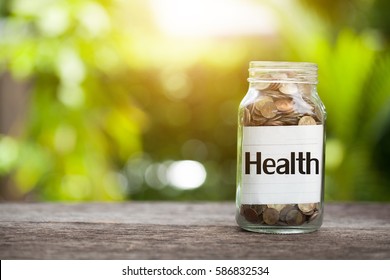 Health Word With Coin In Glass Jar,  Concept Siphons Money And Health Insurance.