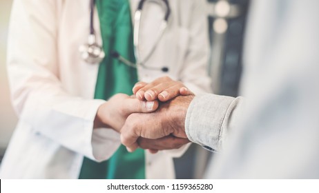 Health worker holding patient's hand