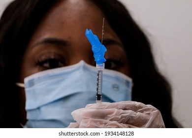 A Health Worker Prepares A Syringe With The New One-shot Johnson And Johnson COVID-19 Vaccine At A Vaccination Event At Baldwin Hills Crenshaw Plaza In Los Angeles On March 11, 2021. 