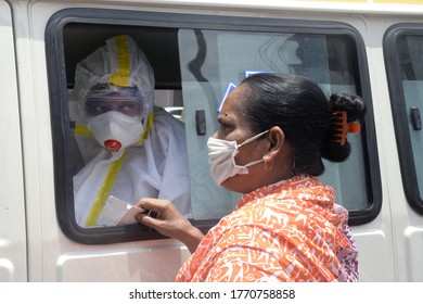 Health Worker Speaks To Woman Before Collecting Swab Samples For COVID 19 Testing At A Mobile Collection Van On July 1,2020 In Kolkata.