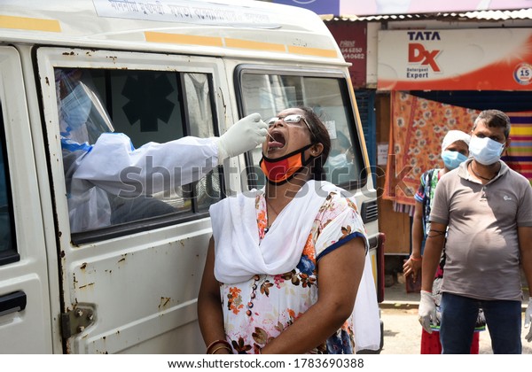 A health worker taking a swab\
test of a woman during the lockdown, in Kolkata on July 25,\
2020