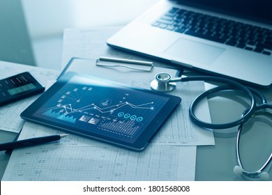 Healthcare Business Concept, Medical Examination And Graph Data Growth Of Business On Tablet With Doctor's Health Report Clipboard On Background.