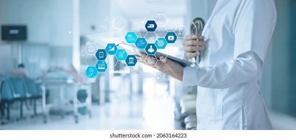 Healthcare business and Medical examination, Doctor use tablet and icon medical with analyzing data and growth chart on hospital background, Health Insurance, Medical business and technology concept.