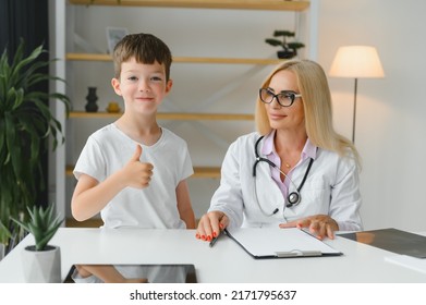 Healthcare For Children: Little Boy Talking To Doctor During Visit To Hospital