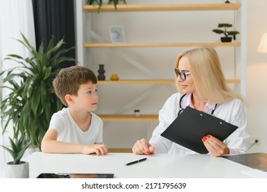 Healthcare For Children: Little Boy Talking To Doctor During Visit To Hospital