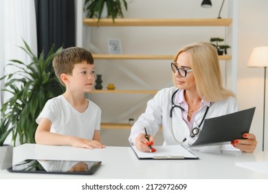 Healthcare For Children: Little Boy Talking To Doctor During Visit To Hospital