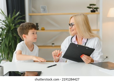 Healthcare For Children: Little Boy Talking To Doctor During Visit To Hospital