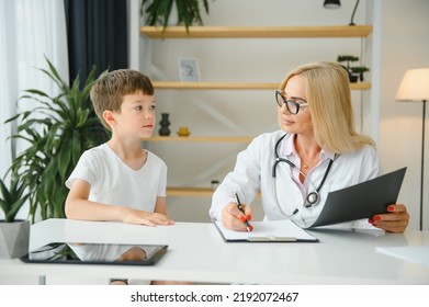 Healthcare For Children: Little Boy Talking To Doctor During Visit To Hospital