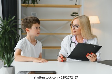 Healthcare For Children: Little Boy Talking To Doctor During Visit To Hospital