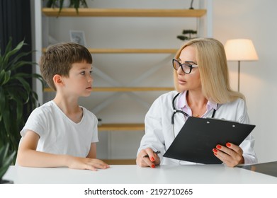 Healthcare For Children: Little Boy Talking To Doctor During Visit To Hospital