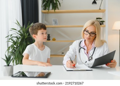 Healthcare For Children: Little Boy Talking To Doctor During Visit To Hospital