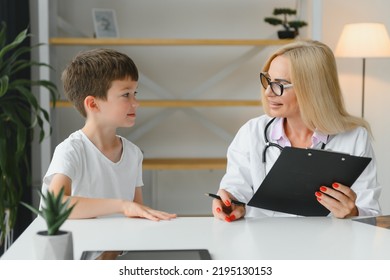 Healthcare For Children: Little Boy Talking To Doctor During Visit To Hospital