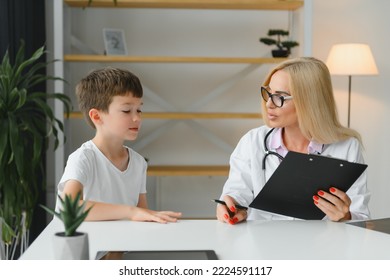 Healthcare For Children: Little Boy Talking To Doctor During Visit To Hospital