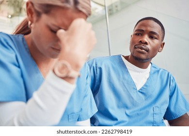 Healthcare, collaboration or loss and a sad nurse in the hospital with a man colleague showing compassion. Medical, death and insurance with a black male medicine professional consoling a friend - Powered by Shutterstock