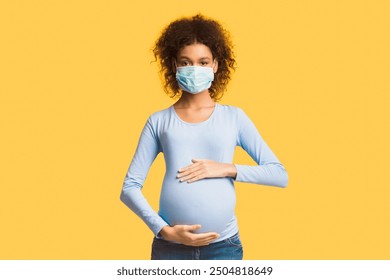 Healthcare concept. Afro pregnant woman in protective mask against flu and viruses, white background - Powered by Shutterstock