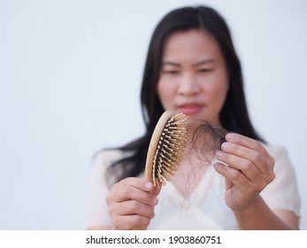 Healthcare concept. Closeup hair loss, hair fall in hairbrush stress problem of woman. 