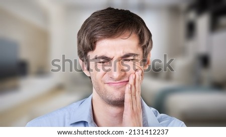 Healthcare concept, man hand on face as suffering from facial pain, mumps or toothache